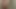 濡れた女の子がシャワーで自分の体を撫でる