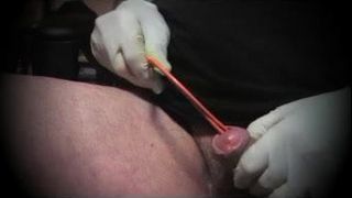 Gay sounding the penis with a round arch folds