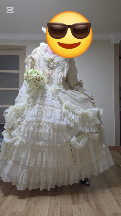 A man dressed as a woman dances in a dress.