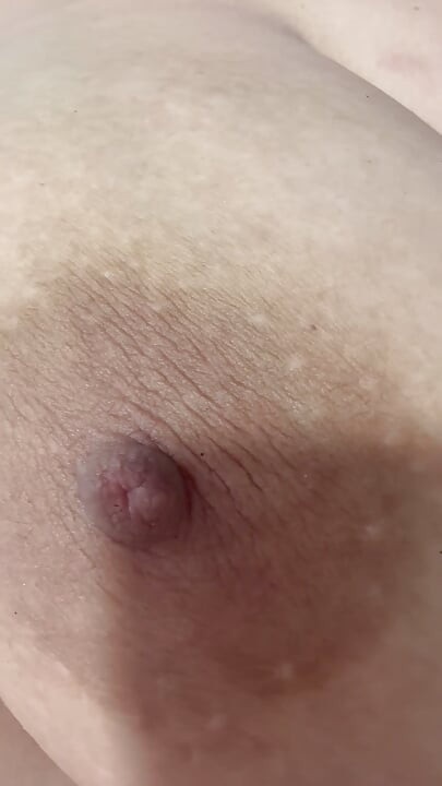 Mom plays with her big and delicious nipples