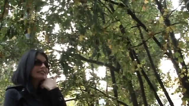 Hot and sexy milf fingers her pussy on the bench of a park