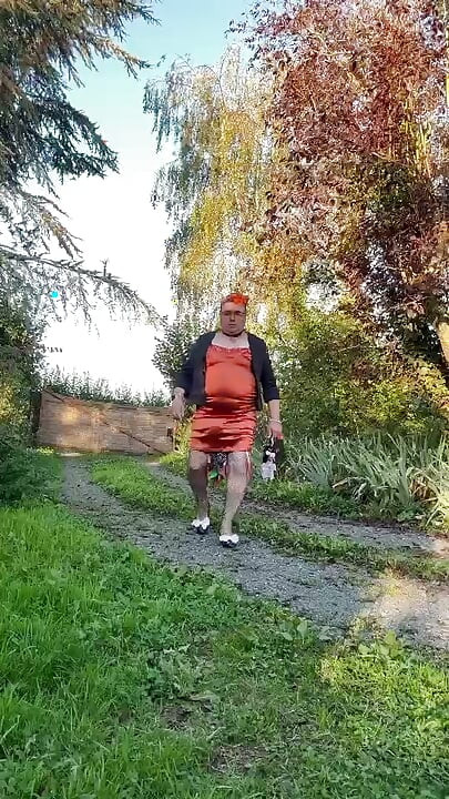 Dressed in a tight-fitting orange dress for a night out
