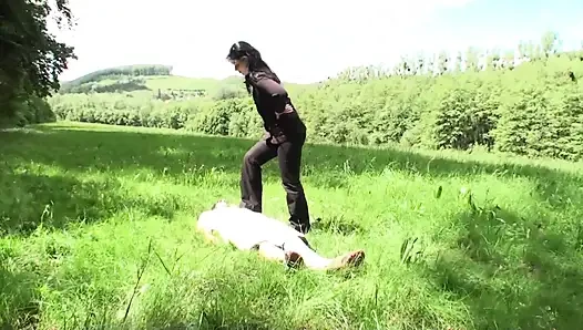 Outdoor trampling punishment with muddy shoes