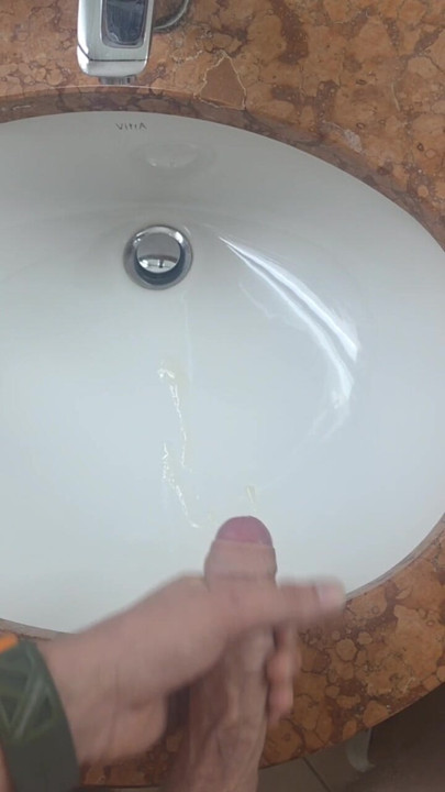 Secretly jerking off and cumming in the hotel bathroom while a friend can just walk in.