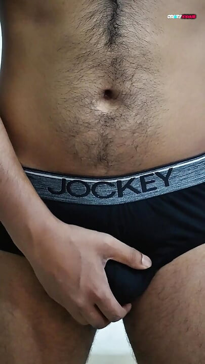 A sexy guy is dancing while holding his cock.