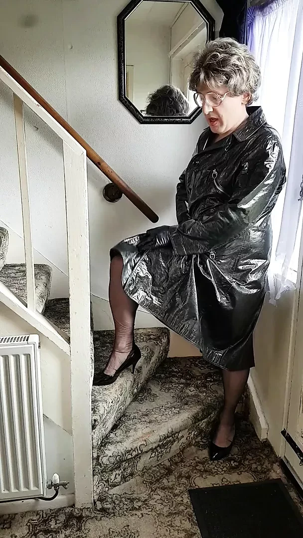 Cute Aunty Honey loves to play with her cock in her pvc mac