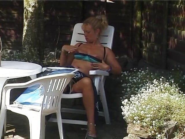 Blonde mature rubs her twat outdoors
