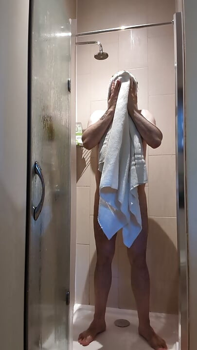Chastity locked bear takes a ahower