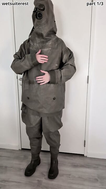 Putting on Zodiac Zodiak heavy rubber hazmat suit over plastic pants and gas mask
