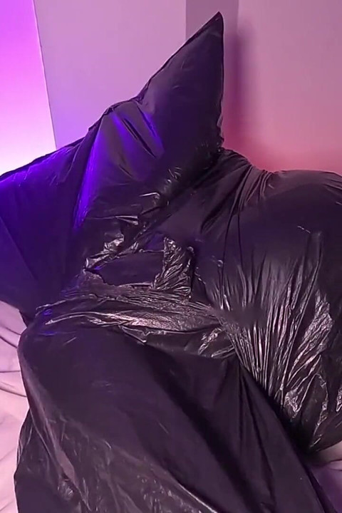 Girl in Garbage Bag Plays with Her Breath