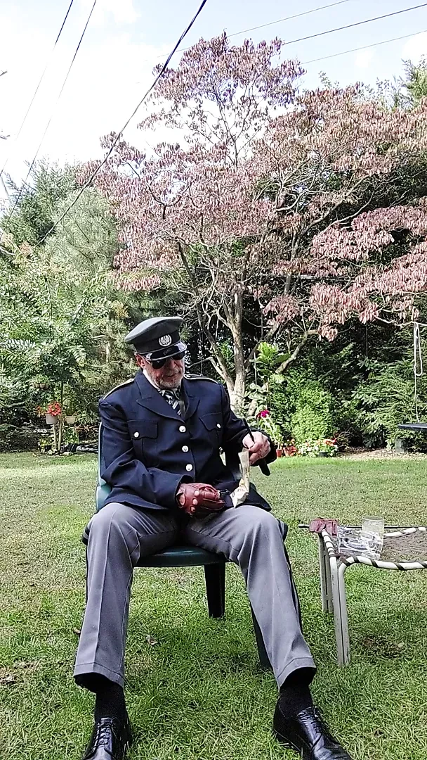 Military officer enjoys smoking his pipe and getting off