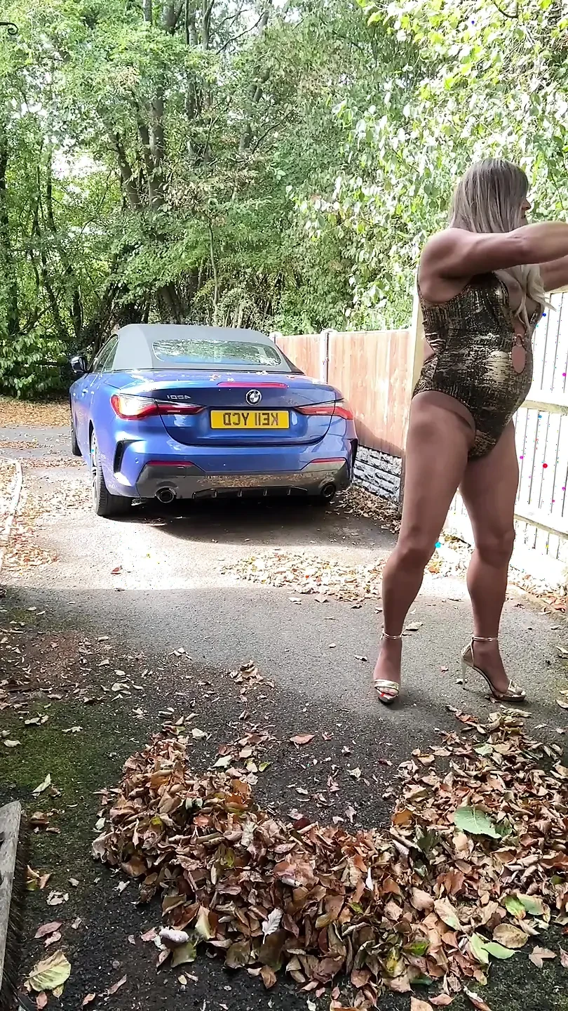 Sexy Crossdresser kellycd2022 in gold swimsuit and heels clearing leafs