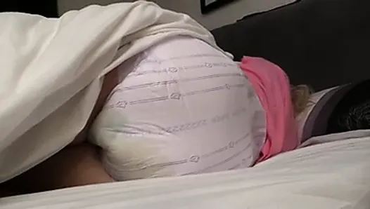 Diaper girl Sky wetting her diaper while in bed