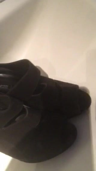 Cumming on black sandals