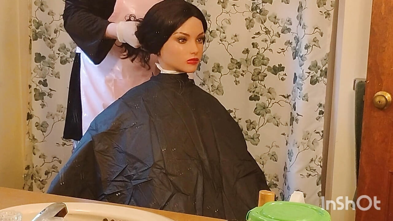 Emma the barberette shows off sexy vinyl shampoo capes