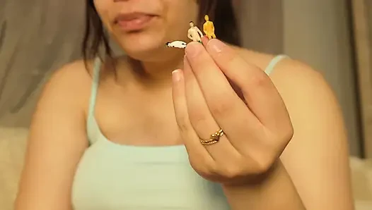 Giantess Girl Unwraps a Candy but Is Surprised Because There Is a Tiny Man in the Candy Bag - She Is Curious to See What It