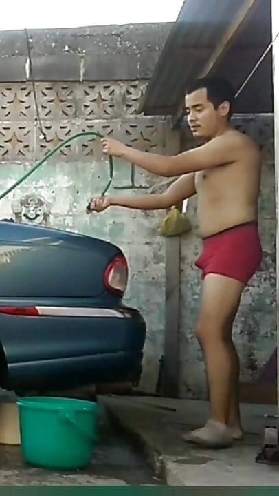 Jesus in red boxer washing his jaguar car