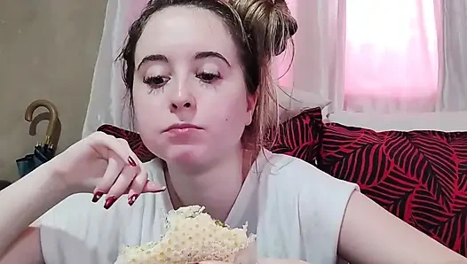 Eating an omelette sandwich with cherry tomatoes