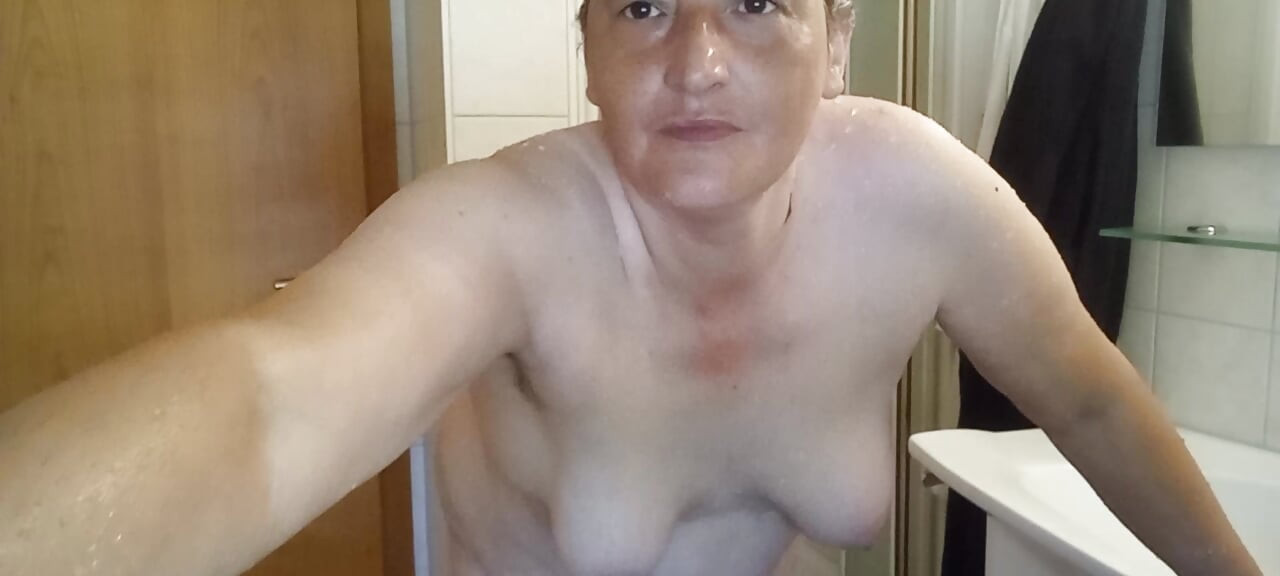 Mature voluptuous woman shows off her wet curves
