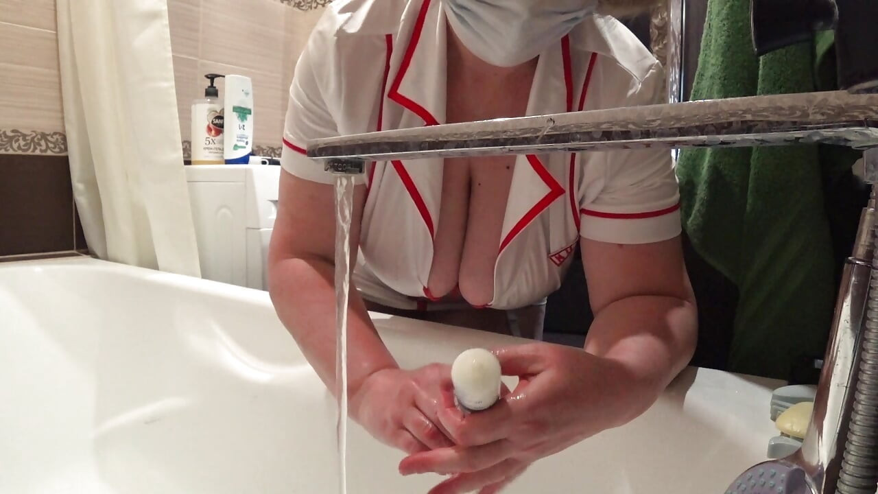 Big Boobs. Gorgeous Cleavage Under a Medical Gown. a Mature Nurse on Camera at Work