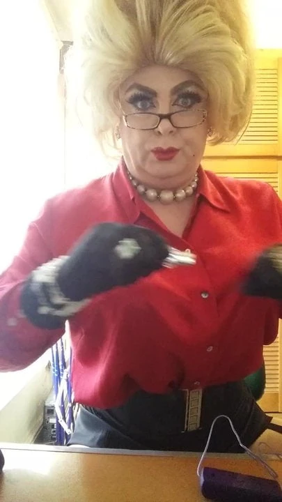 Dolly Lashes adding red lipstick to her lips