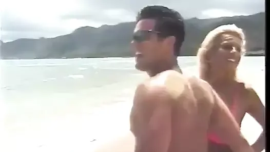Tanned blonde and a dude are fucking on the beach