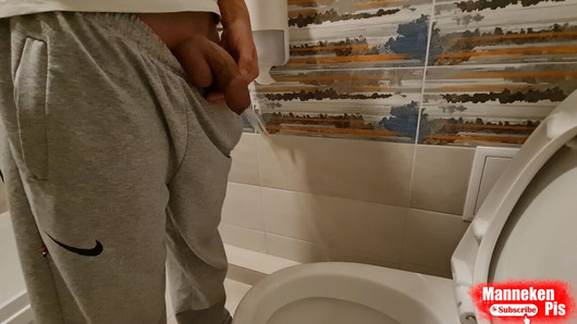 Young boy Mikel pissing at home