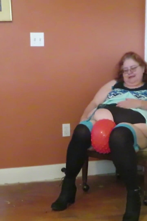Nurse Vicki  plays with a rubber ball in a mini skirt, sexy stockings and high heel mini boots