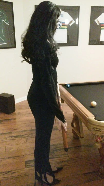 Morticia Addams plays pool