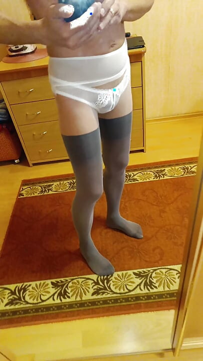 I'm wearing tights and panties and looking at myself in the mirror.