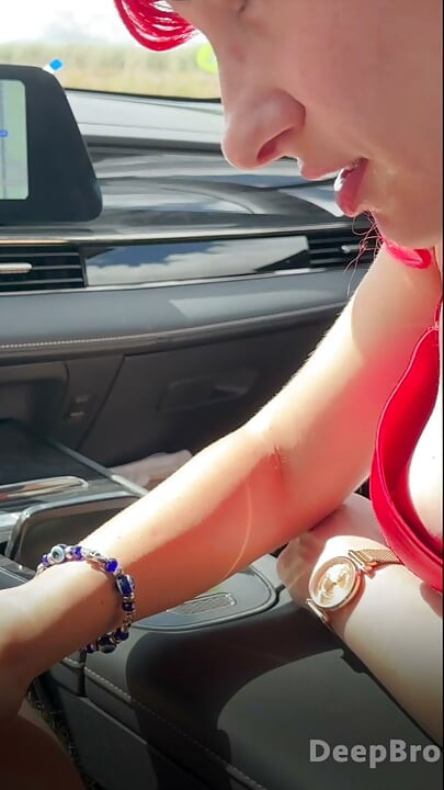 Redhead deepthroats thick BBC in the car, fingers gripping tight