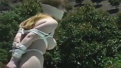 Tied naked girl hops outside
