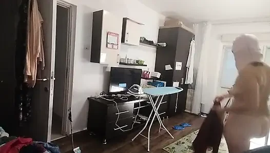 Sexy brunette doing naked chores around the house.