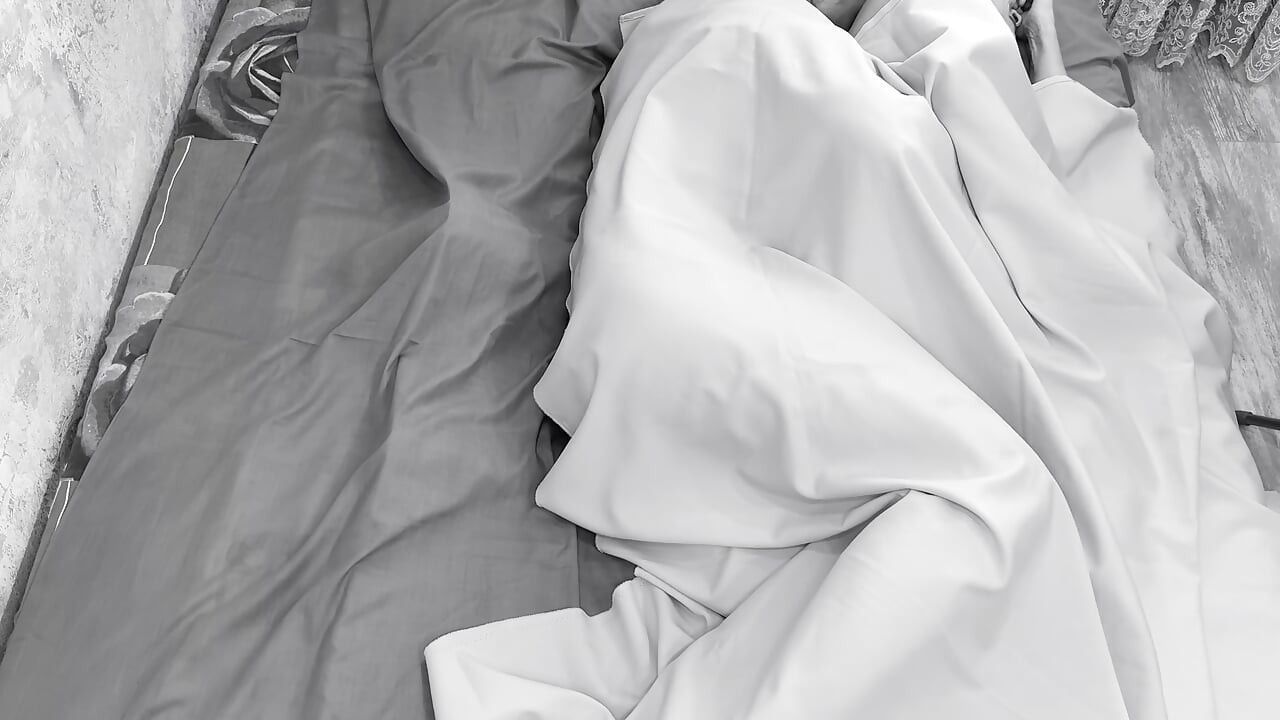 Couple caught on camera having sex in bed .