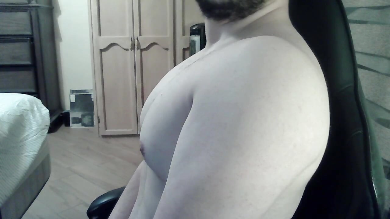 Muscular jock flexes his muscles on can