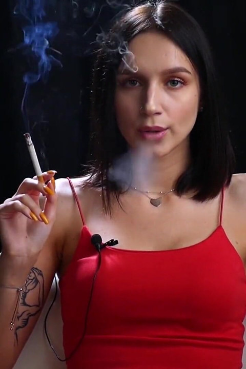 Sexy Lady in Red Is Smoking Two 100mm Reds
