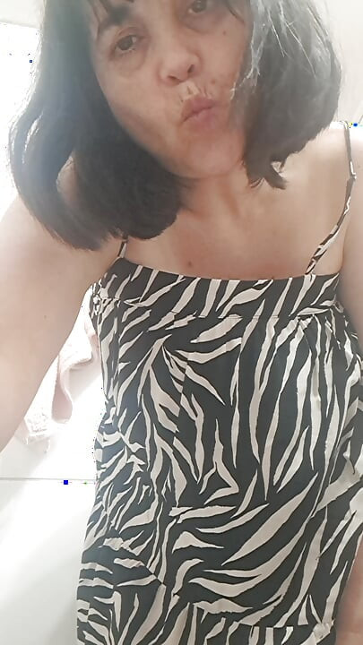 in the bathroom showing what's under her dress to her young lover on camera