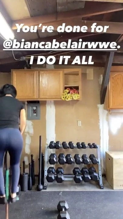 WWE - Bayley bouncing on a pogo stick and lifting a dumbell