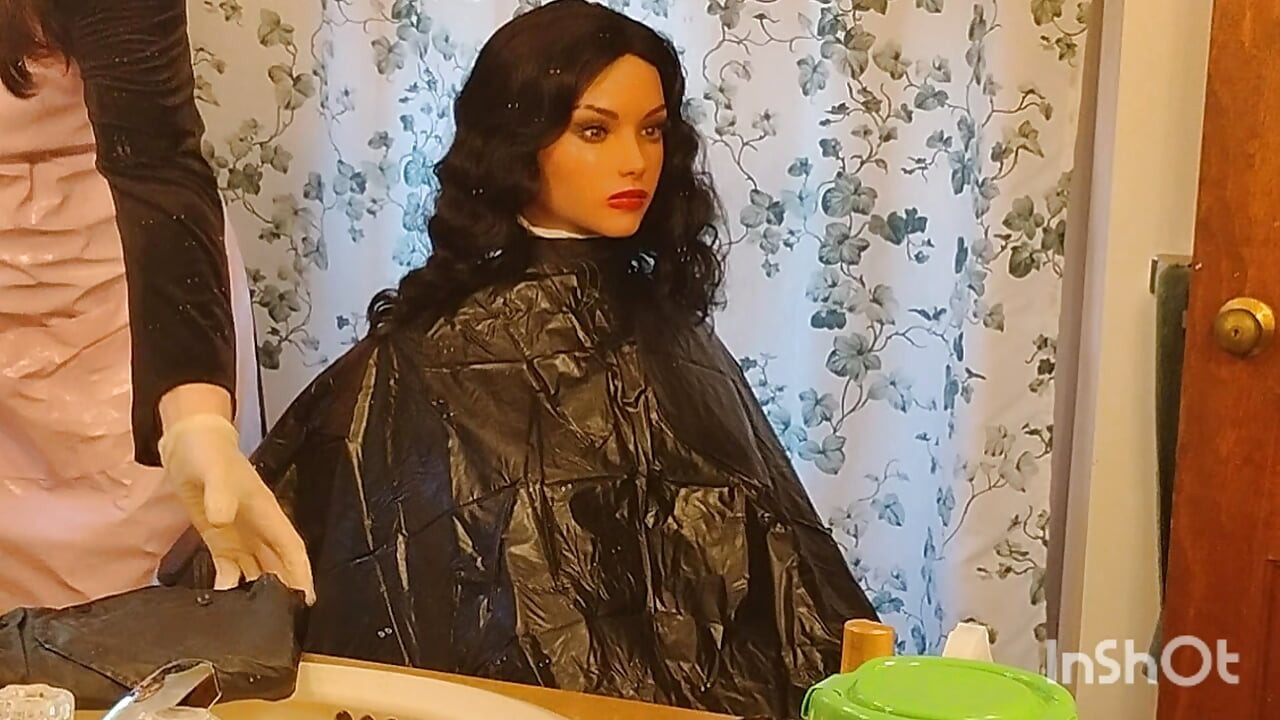 Emma the barberette shows off sexy vinyl shampoo capes