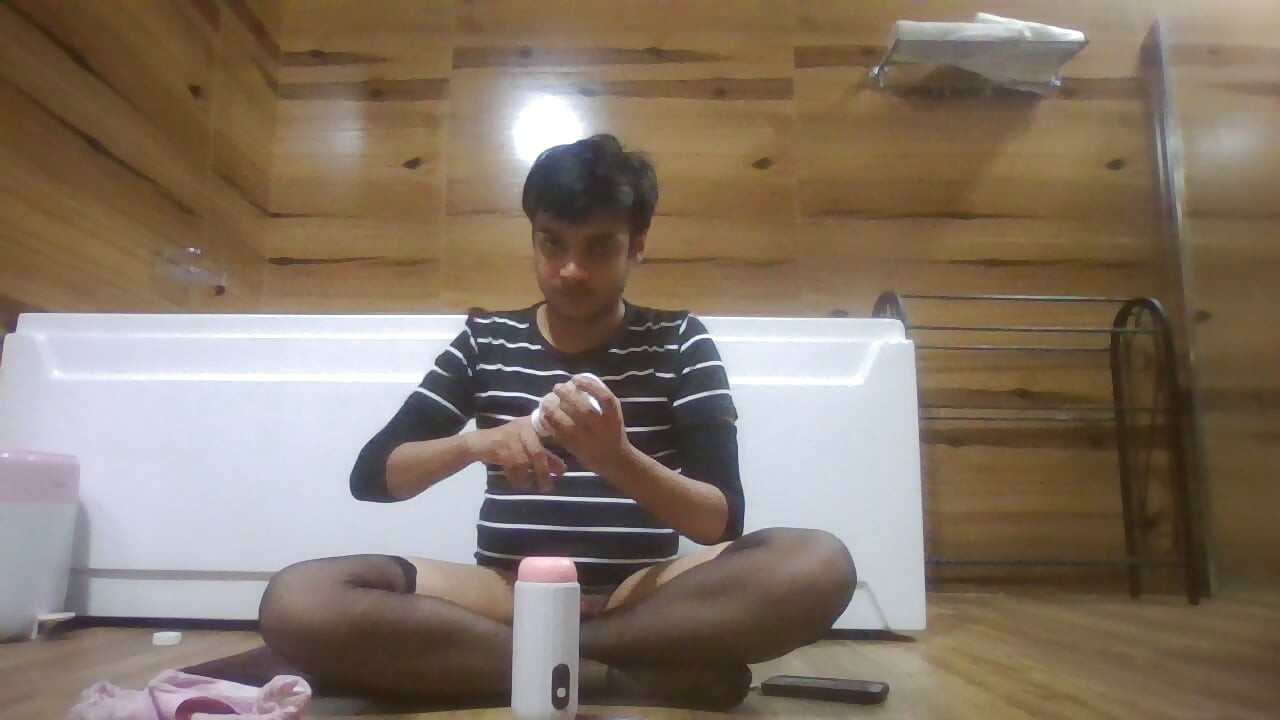 Sexy Sissy in Pantyhose Plays with Pocket Pussy while half naked and watching porn on her phone