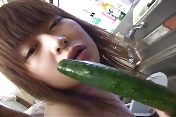 Insatiable Young Wife Drenches Cucumber Deep in Kitchen Sink