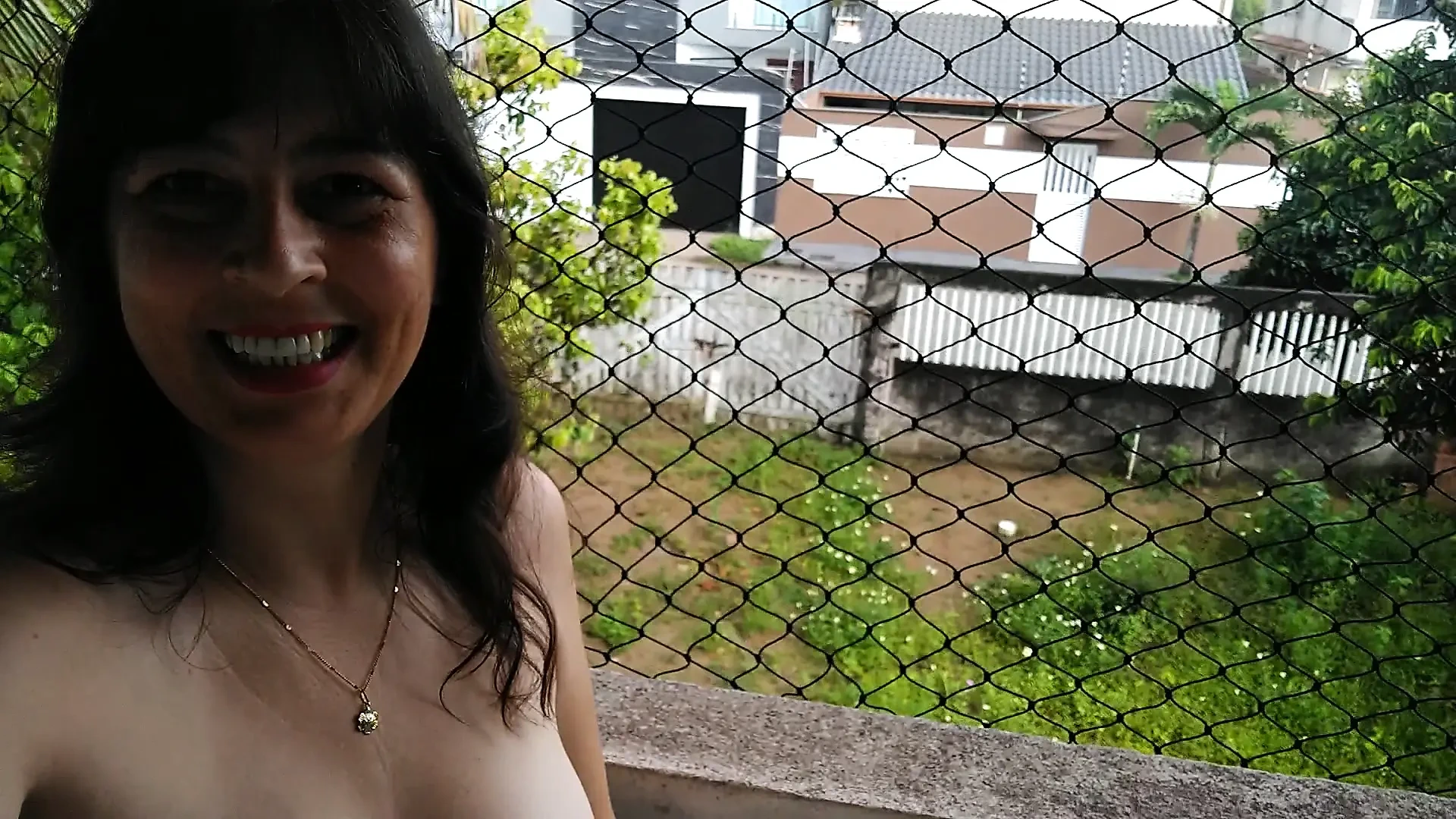 Wife making strip tease on balcony
