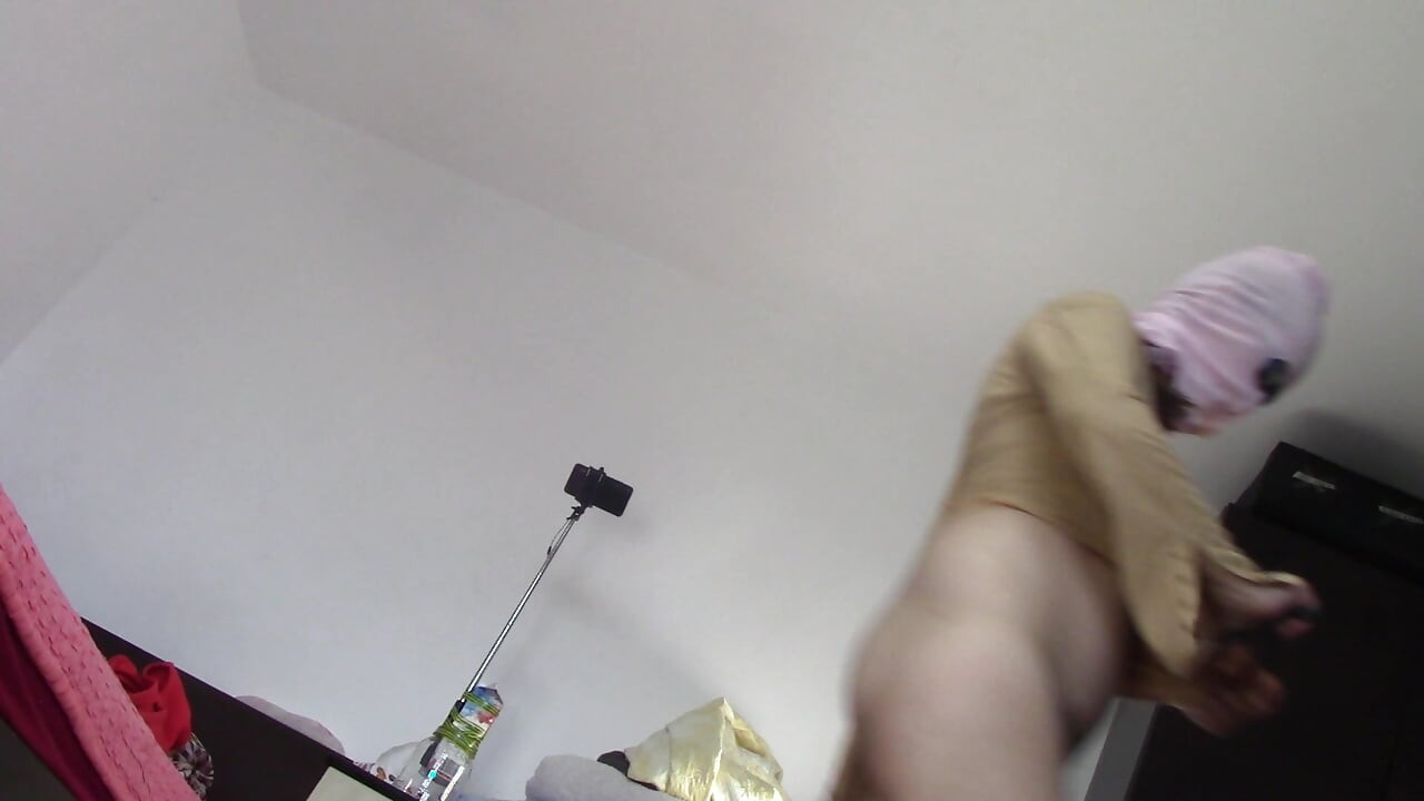 Amateur wife dancing naked at home. Amateur woman has fun trying on clothes and cutting them.