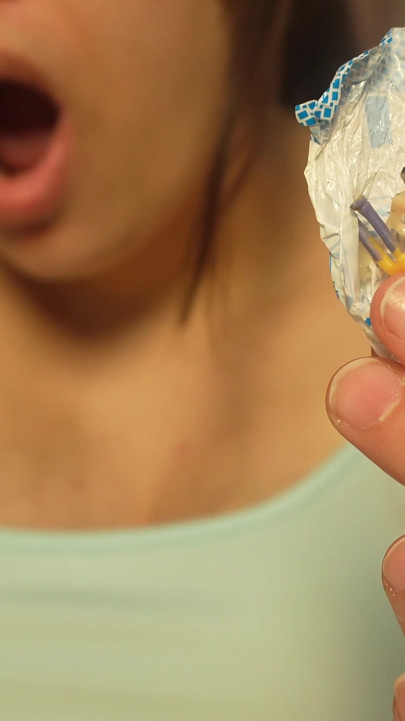 Giantess Girl Unwraps a Candy but Is Surprised Because There Is a Tiny Man in the Candy Bag - She Is Curious to See What It