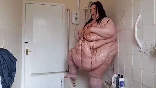 Ssbbw body covered in chocolate sauce in shower