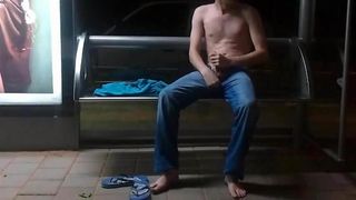 Wanking shirtless at a public bus stop