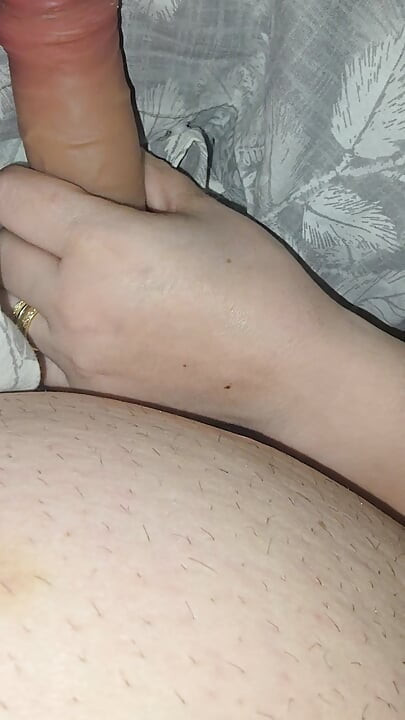 Step sister surprises step brother with a handjob while they watch a movie