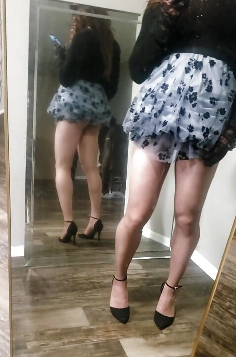 Tgirl teases and poses for the camera while getting undressed