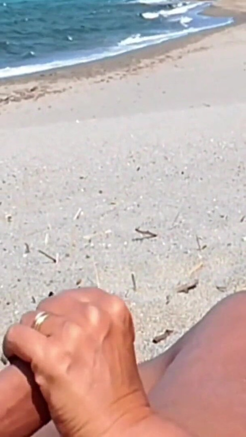 She shows her ass on the beach of Cap d'Agde and jerks off her pussy and then her boyfriend's cock with voyeurs | Clip 2