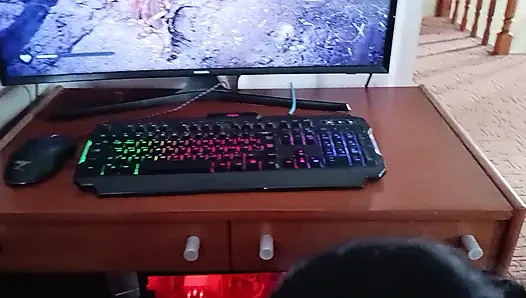 Korean woman sucks a nerd's cock while he's playing on the computer